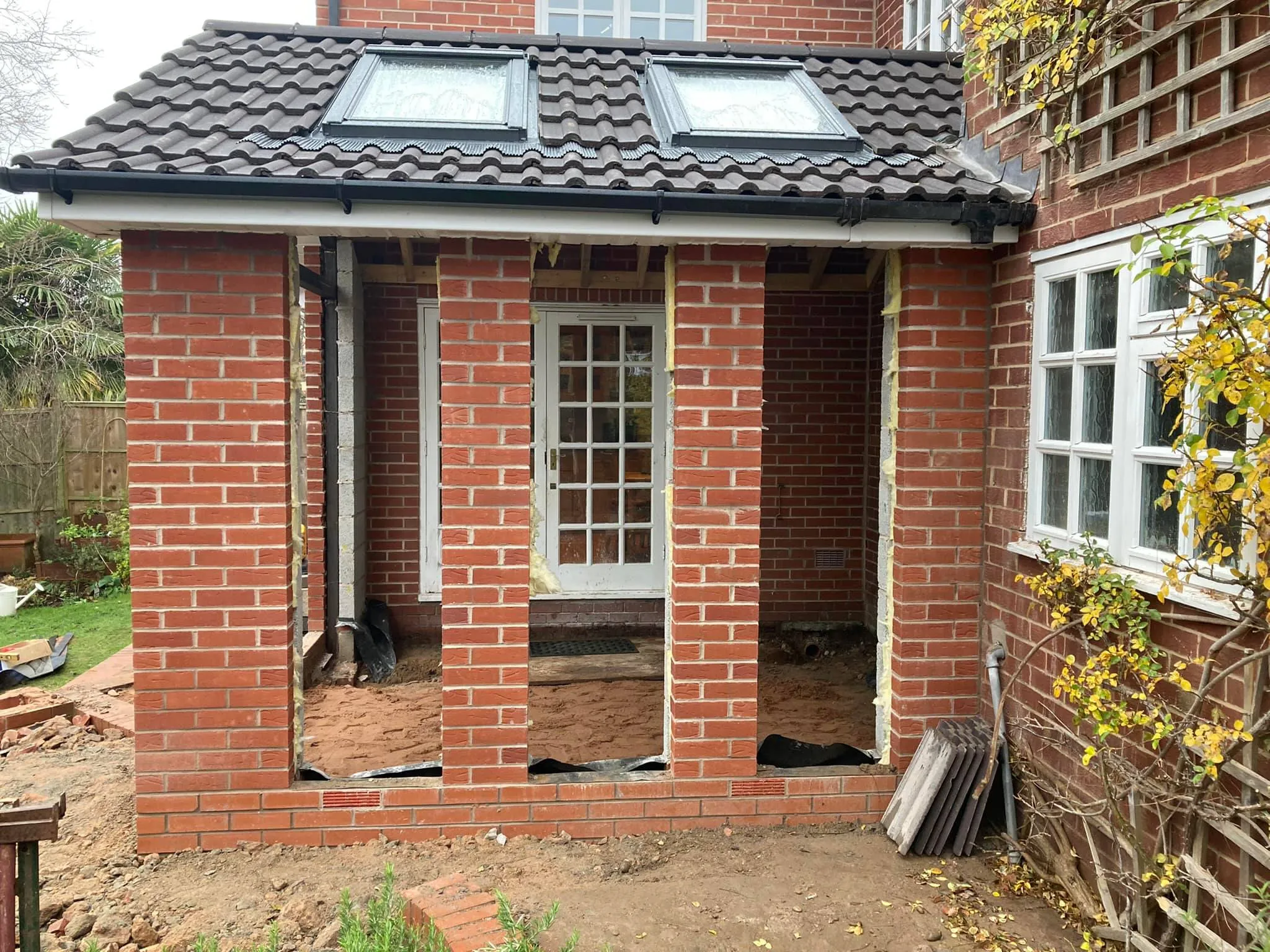 A red brick house with a white window.