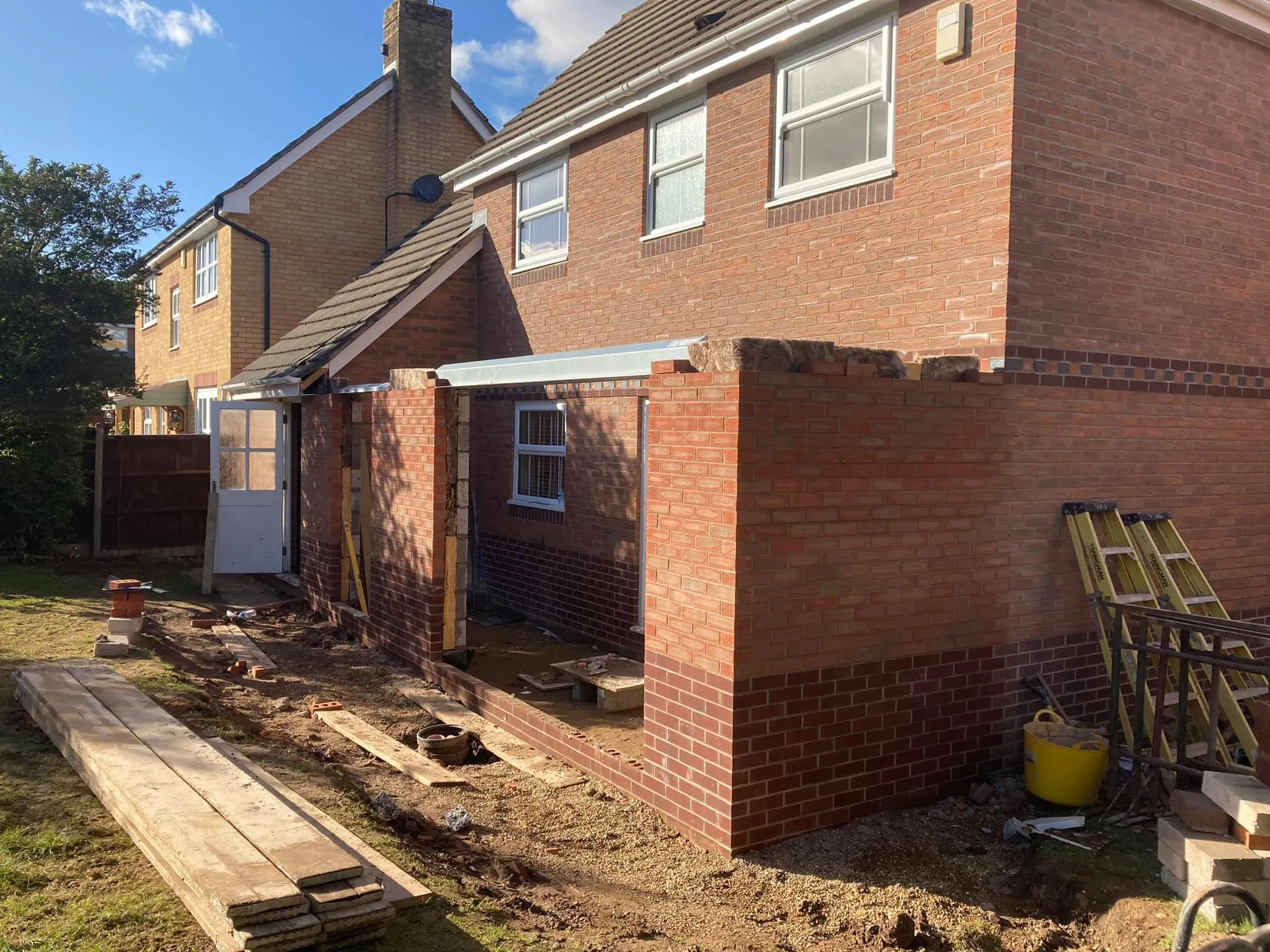 A house being built with a brick wall.