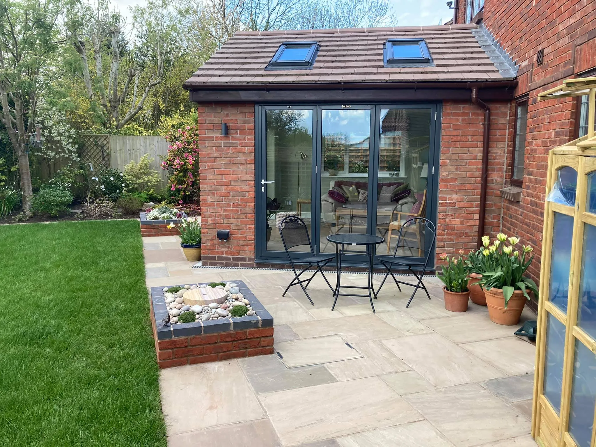 A patio with a table and chairs in it.