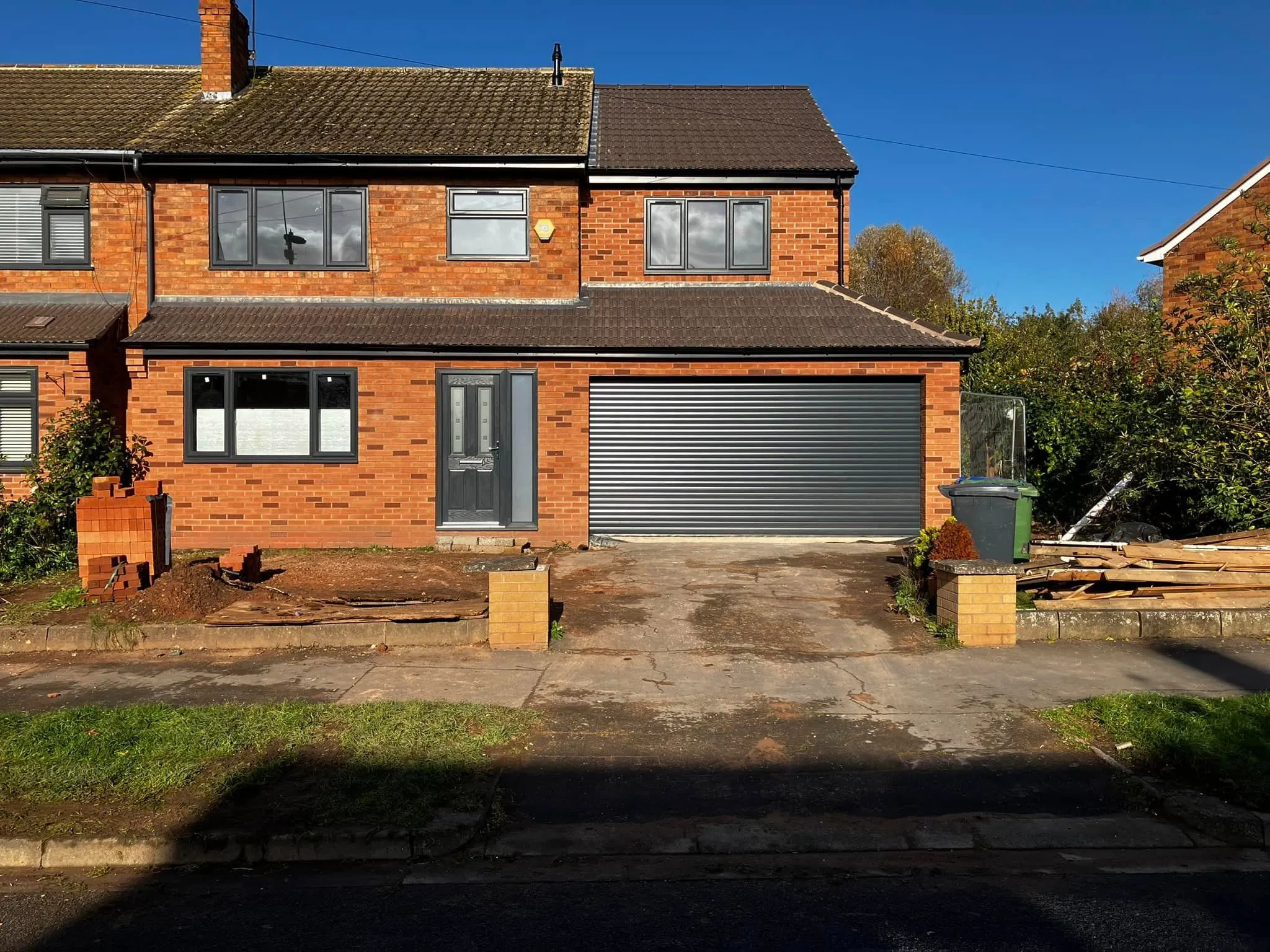 A two story brick house with a garage.