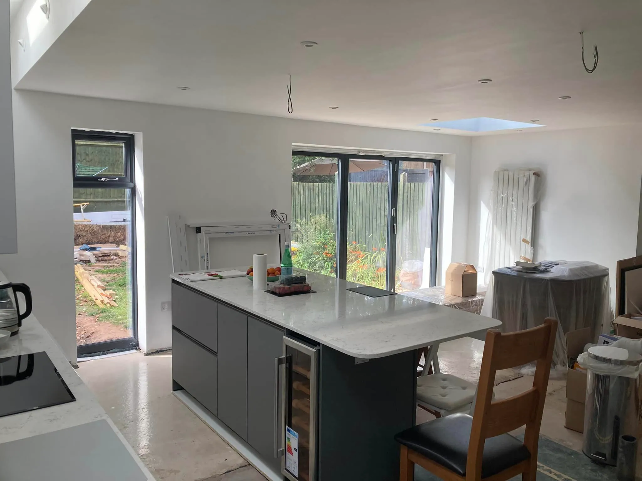 A kitchen with an island and a stove top oven.